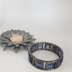 Kenneth Cole Beautiful hinged bracelet with blue glass inserts.